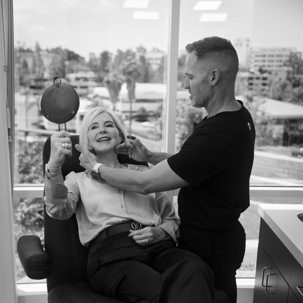 Dr. Taylor Pollei consulting with a rhinoplasty patient
